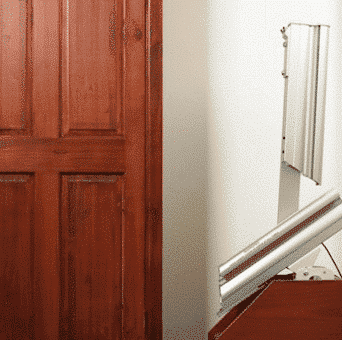 a hinged track stairlift in a home