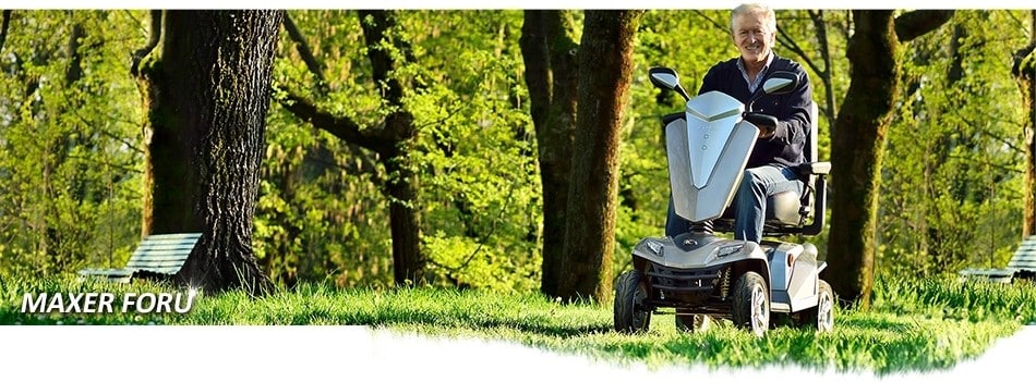 A man driving a Kymco Maxer mobility scooter