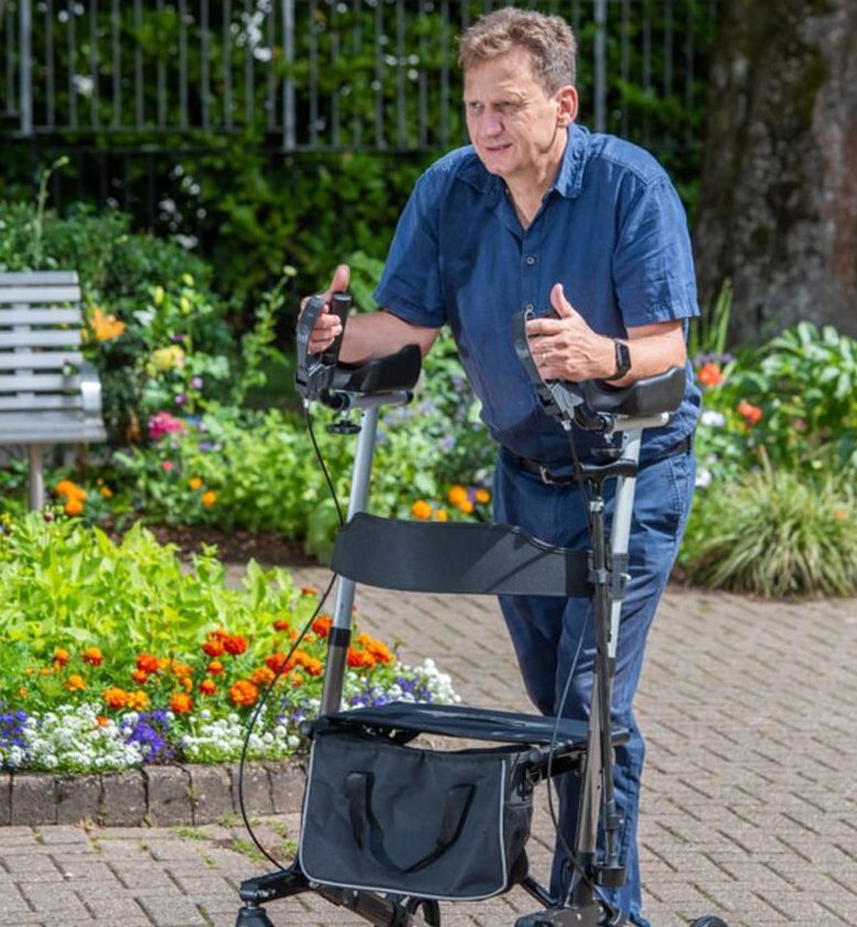 A man using a forearm mobility walker