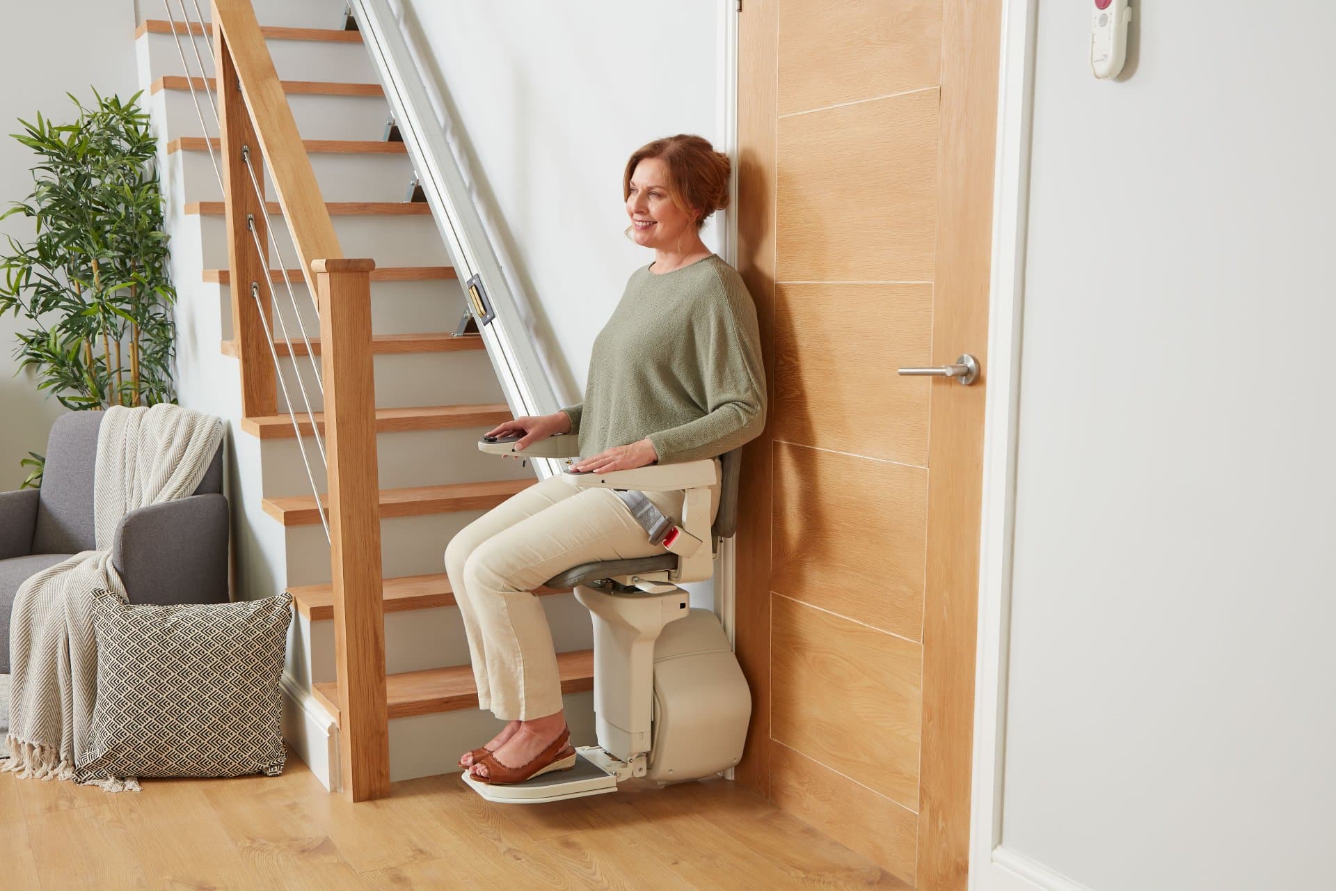 A woman sitting on an Ergo Straight stairlift