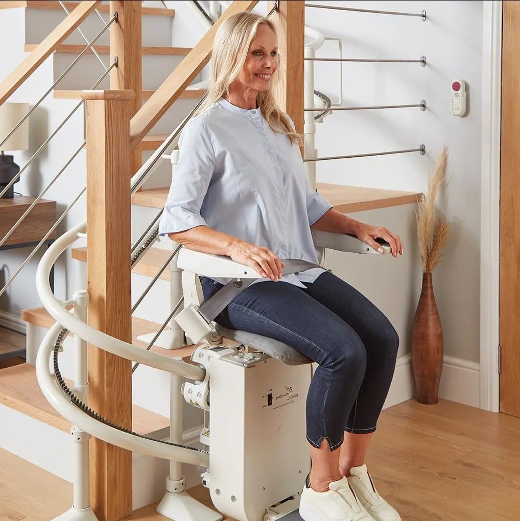 a lady sitting on the ergo curve stairlift