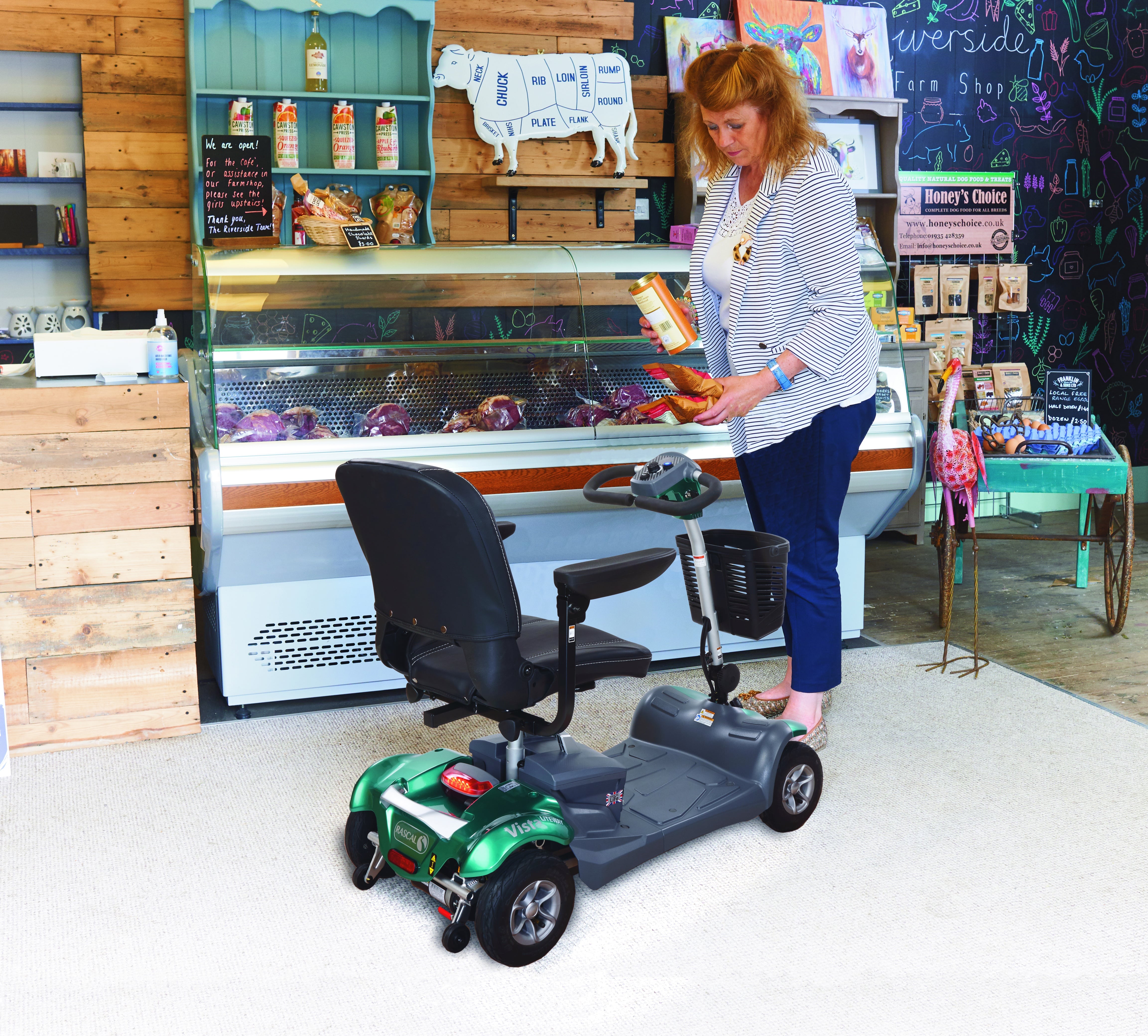 A person using the Vista Liteway mobility scooter in a shop