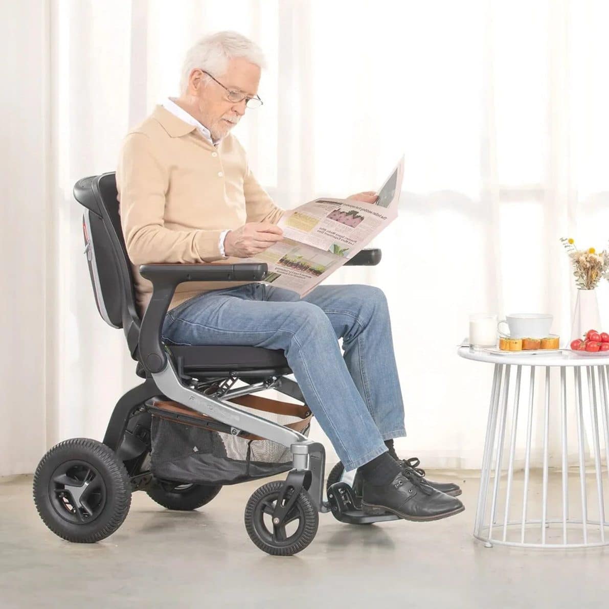 a man reading on a powered wheelchair